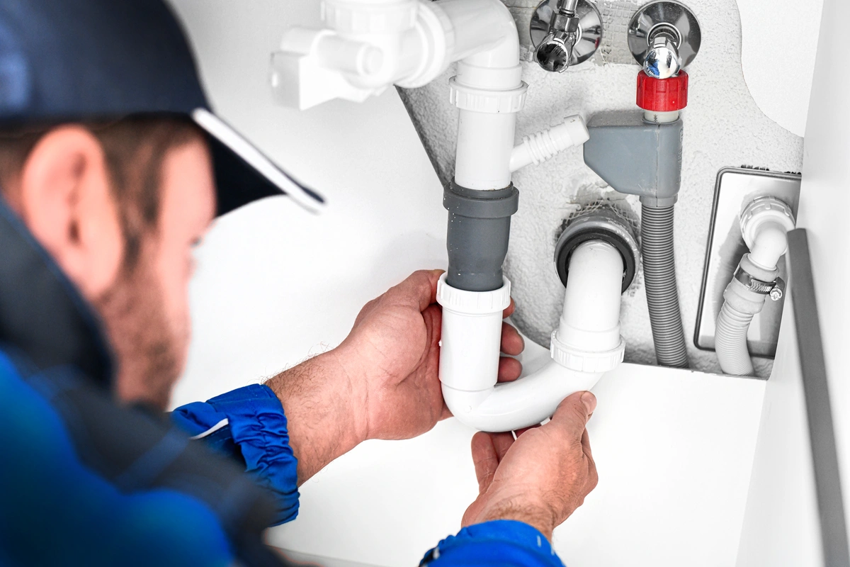 plumber fixes leak in residential home
