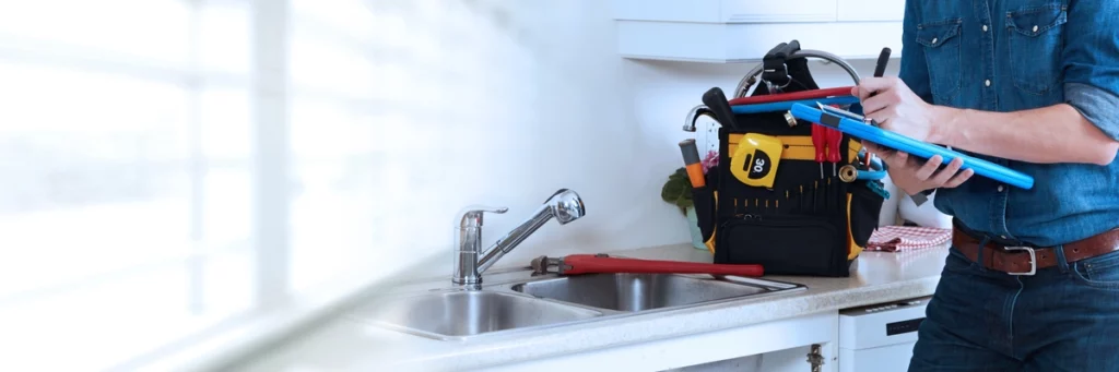 plumber gathers proper tools to replace faucet