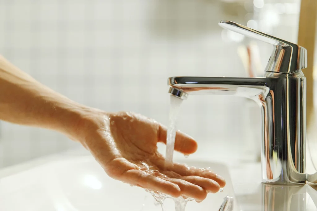 woman tests bathroom faucet water pressure