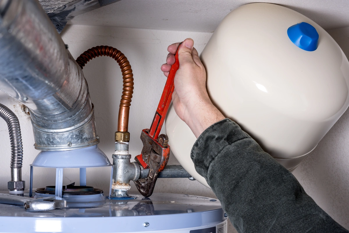 plumber using wrench installs long lasting water heater