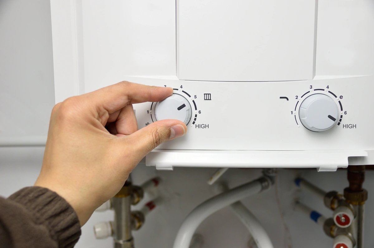 turning the dial on a tankless water heater