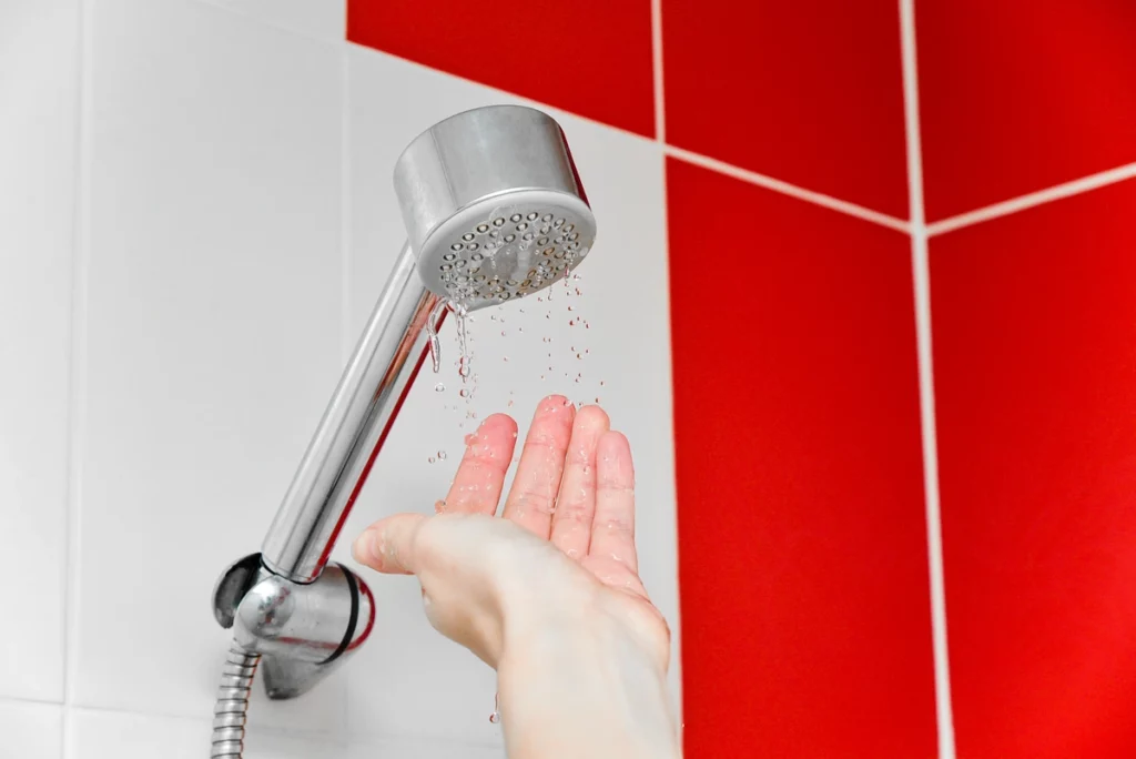 red and white tile bathroom with less water pressure on shower head